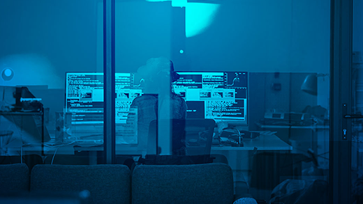 Person sitting in office with computers